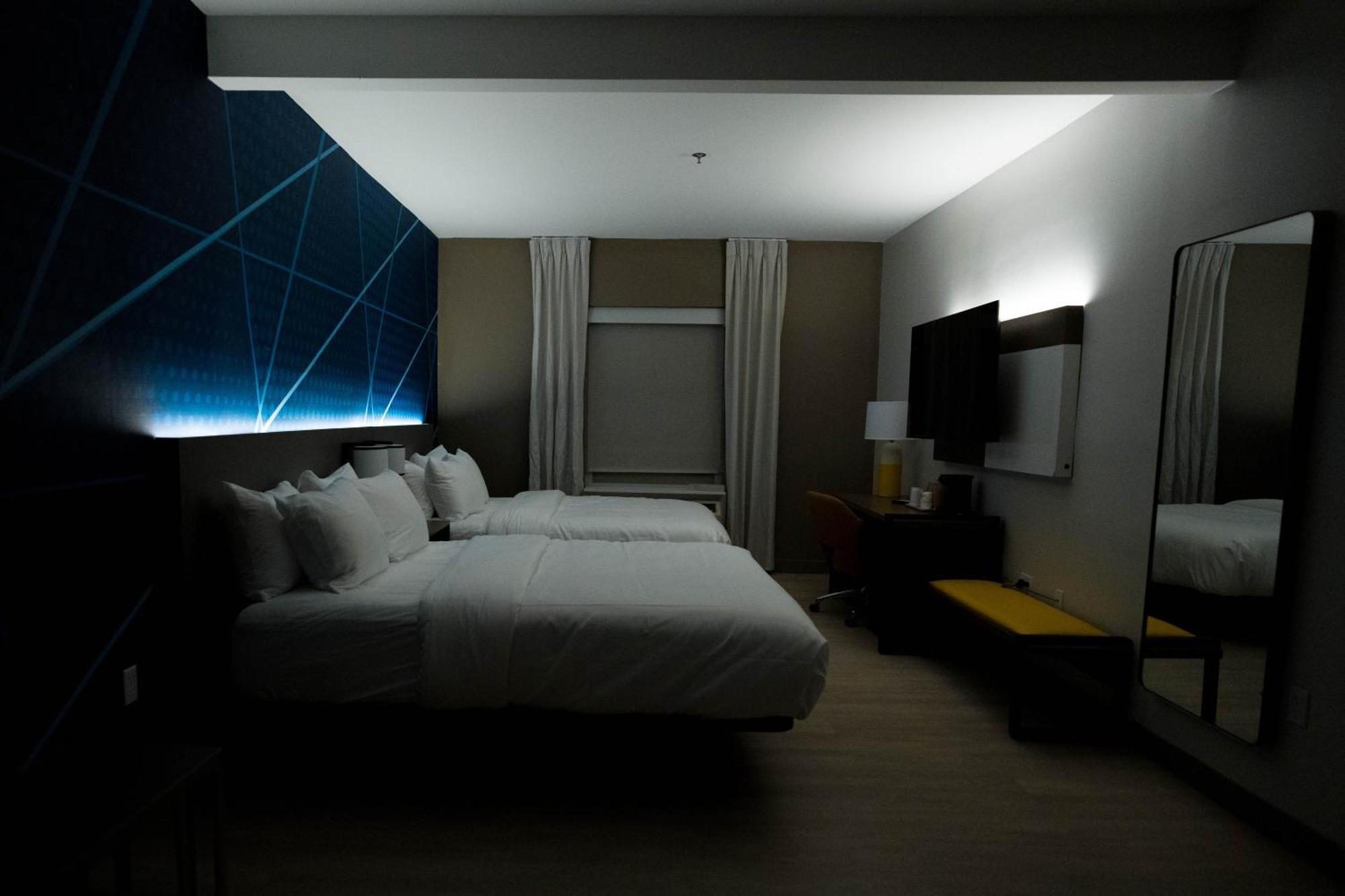 Suite with Two Queen Beds, Walk-In Shower, and Sofa Bed