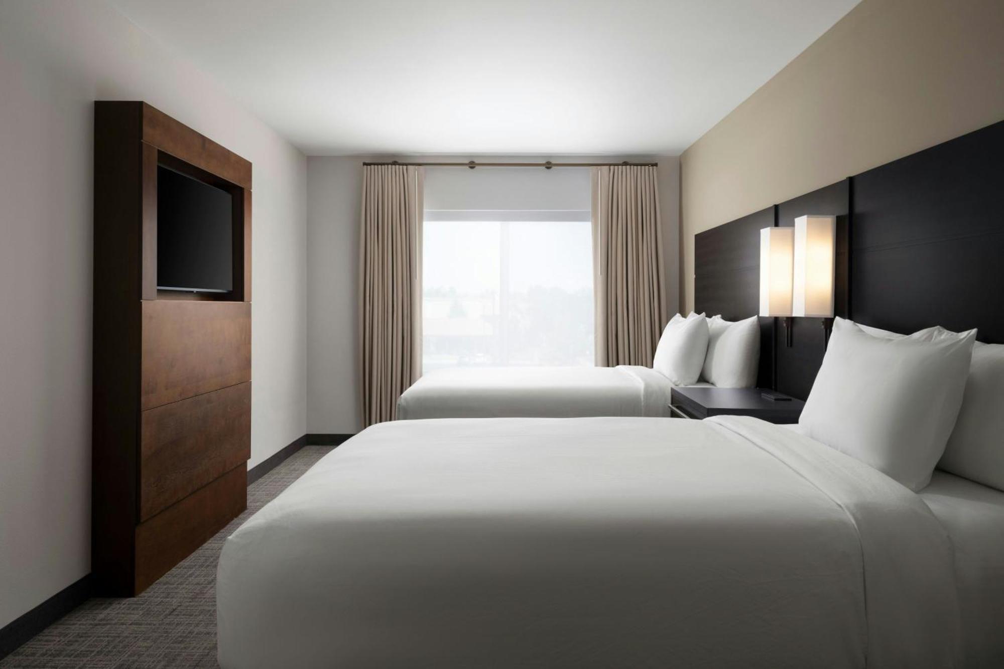One-Bedroom Suite with Two Queen Beds, Sofa Bed, and Roll-in Shower - Mobility Accessible