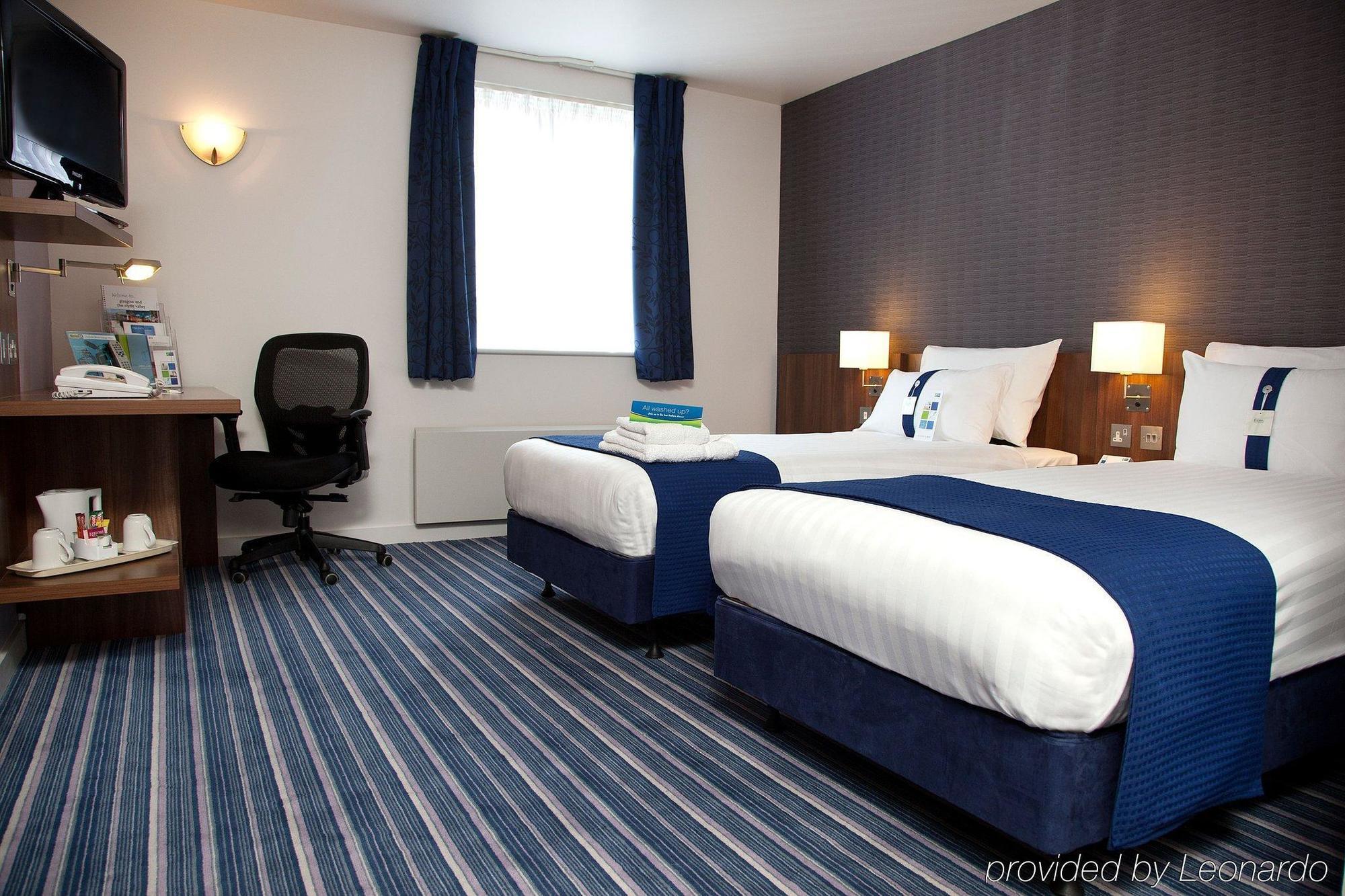 Habitación con cama extragrande y sofá cama